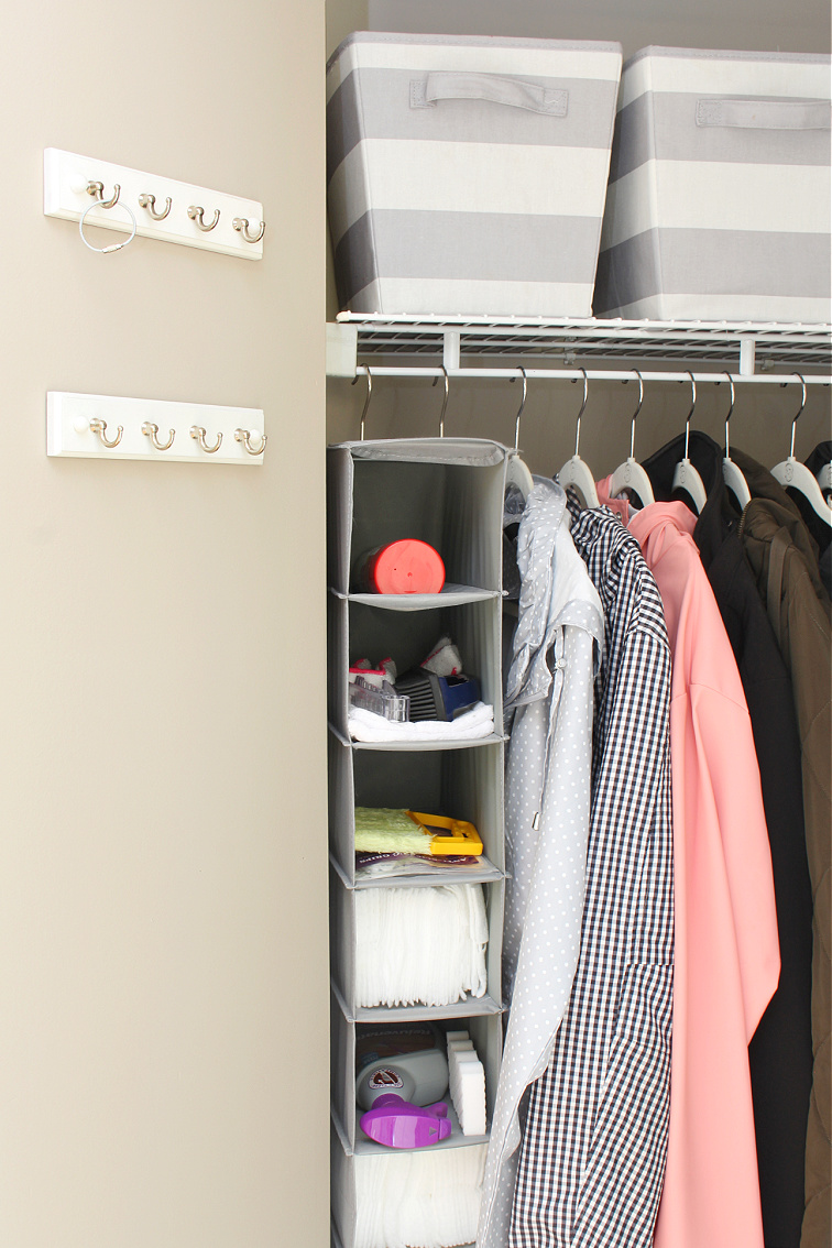 Organized small closet using a hanging shoe closet organizer.