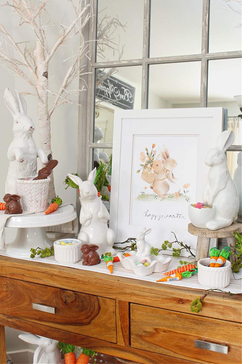 Happy Easter free Easter bunny printable displayed with white ceramic bunnies.