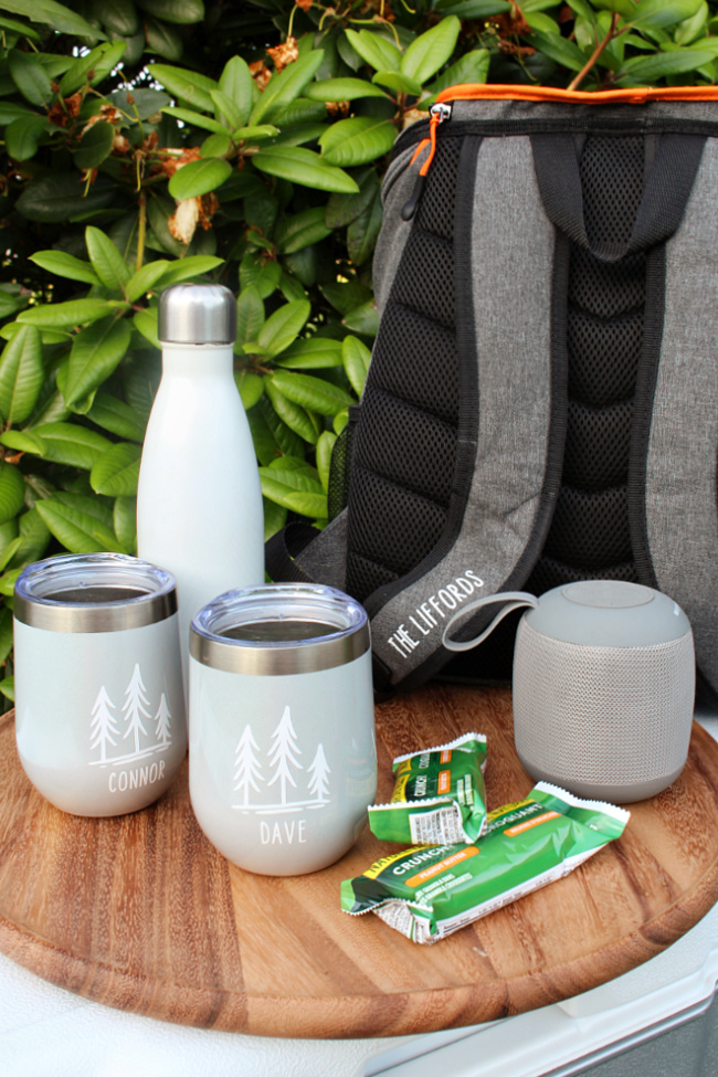 Personalized camping gift basket using an ice cooler backpack.