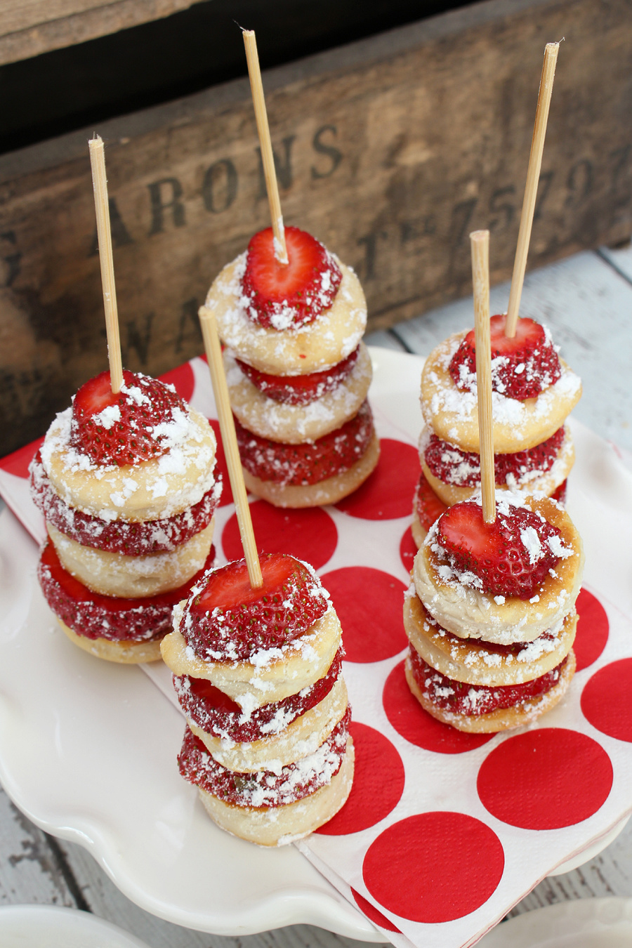 Strawberry shortcake kabobs topped with icing sugar.