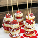 Strawberry shortcake kabobs topped with icing sugar.