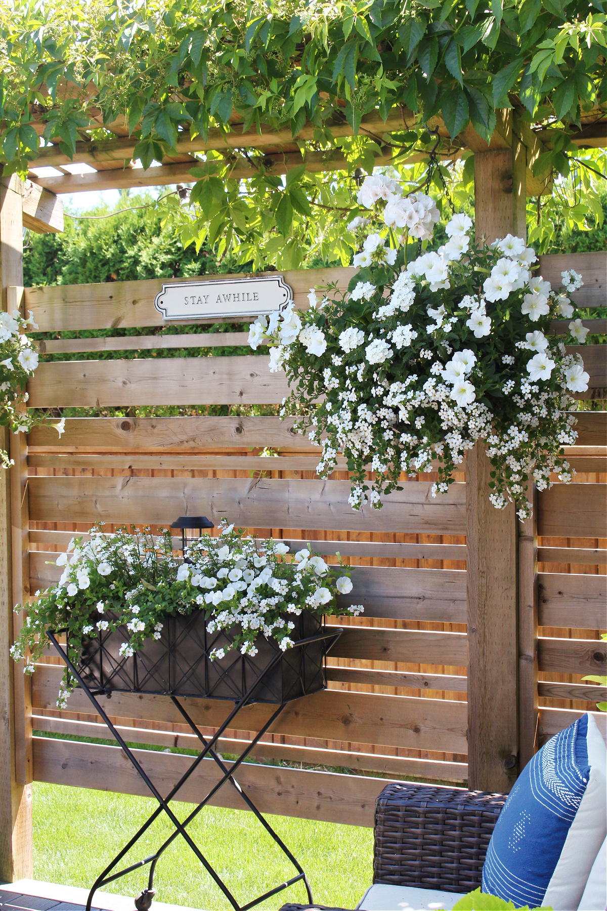 Beautiful white summer flower hanging baskets and planters.