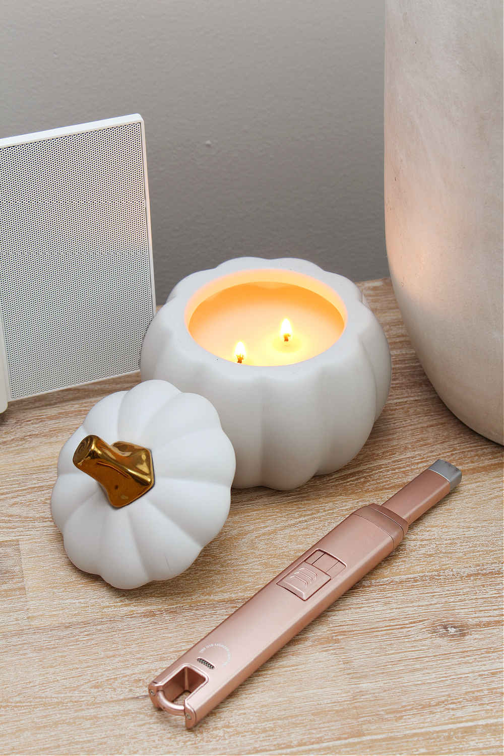 Pumpkin candle on a bedside table.