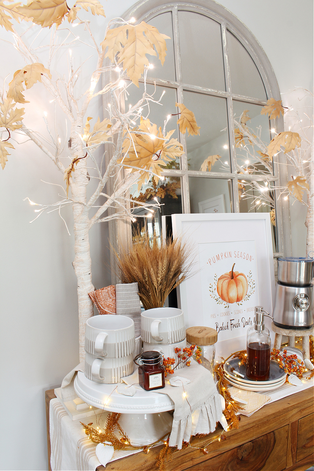 Fall coffee bar with twinkle lights and lighted trees.