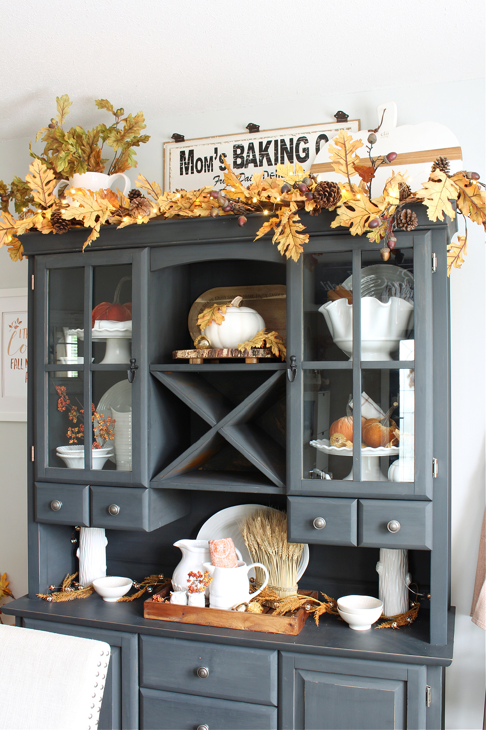 Black painted hutch decorated for fall with traditional fall colors.