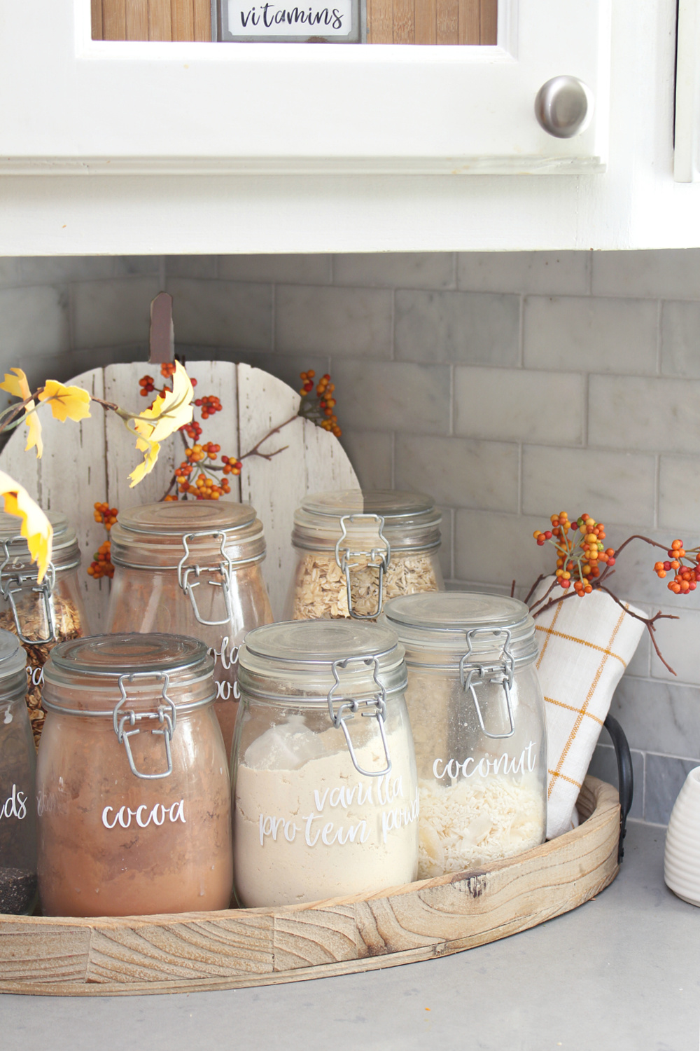 Kitchen smoothie bar with glass jars decorated for fall.