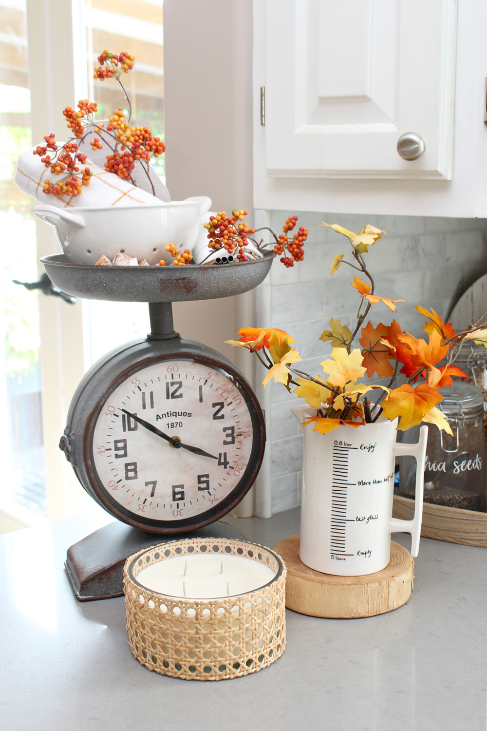 Kitchen scale clock decorated for fall with traditional fall colors.