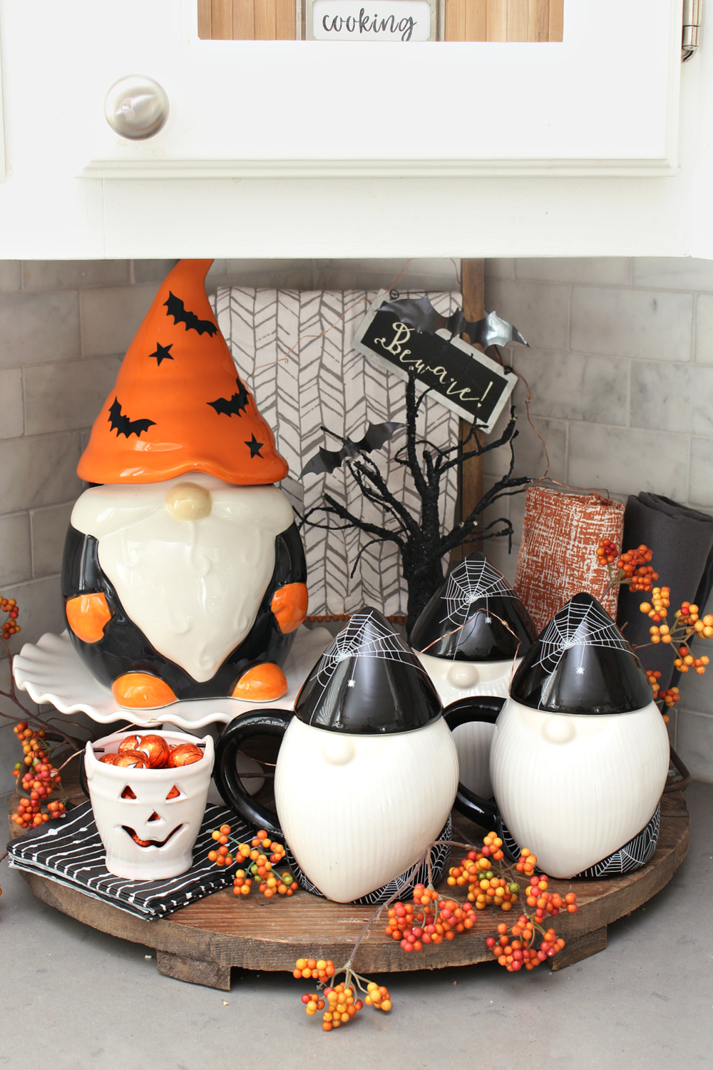 Cute Halloween vignette with Halloween gnome mugs and cookie jar. 