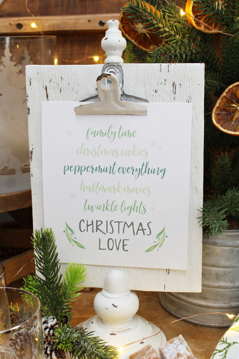 Christmas Love free Christmas printable on a clipboard frame.