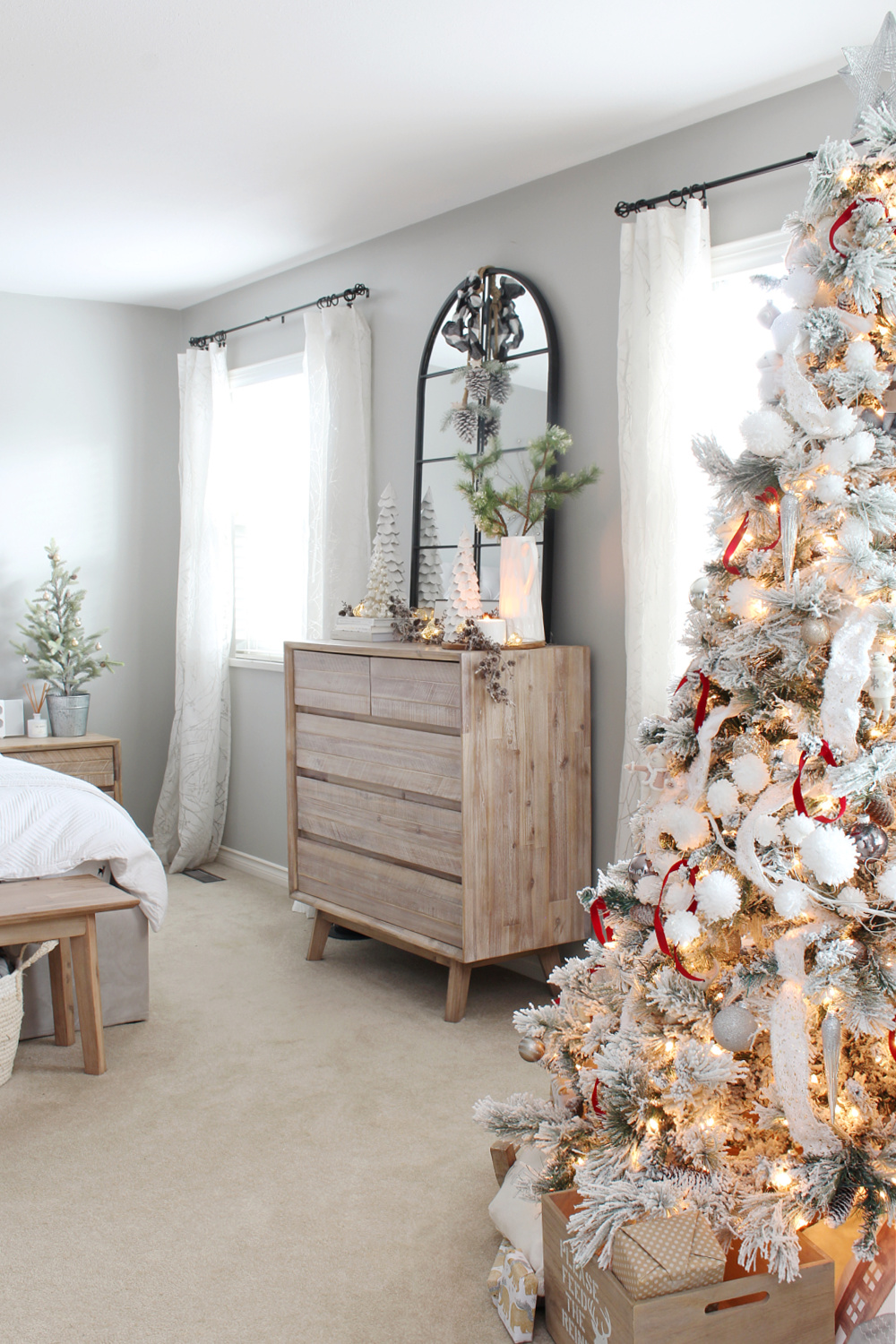Bedroom decorated for Christmas with Christmas tree.