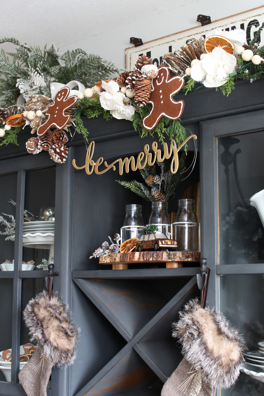 Black painted hutch decorated with a DIY felt gingerbread man bunting.