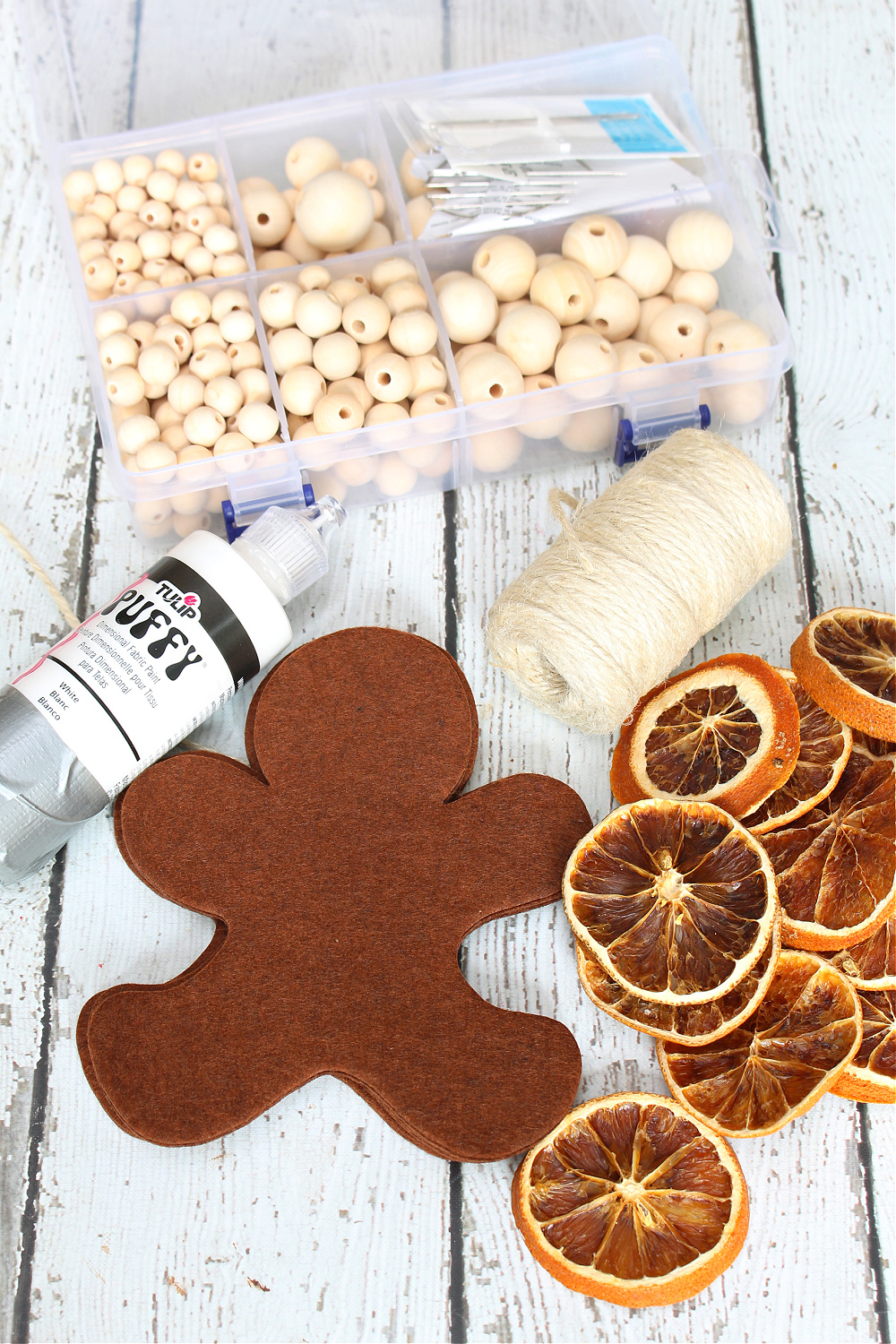 Materials for a DIY felt gingerbread man garland.