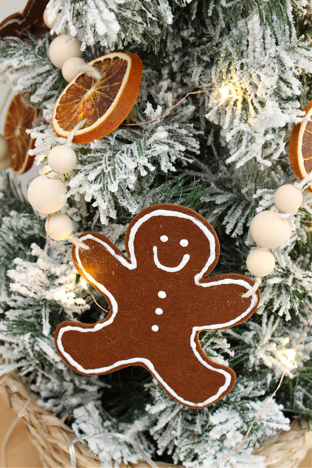 DIY felt gingerbread man garland on a flocked tree.