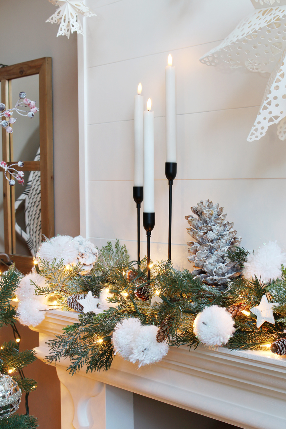 Winter wonderland Christmas mantle with black metal candlesticks.