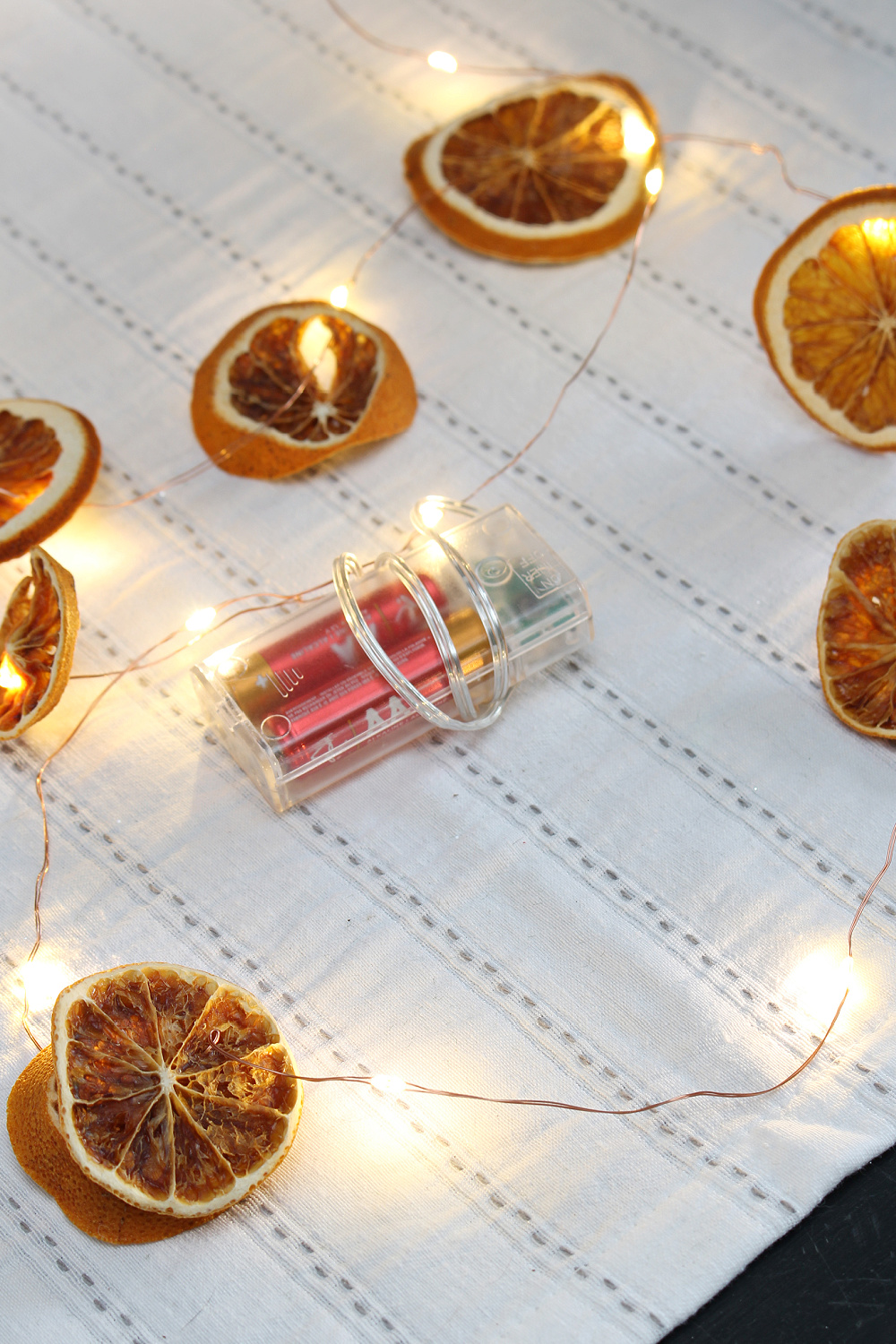 Battery operated lights with dried oranges.