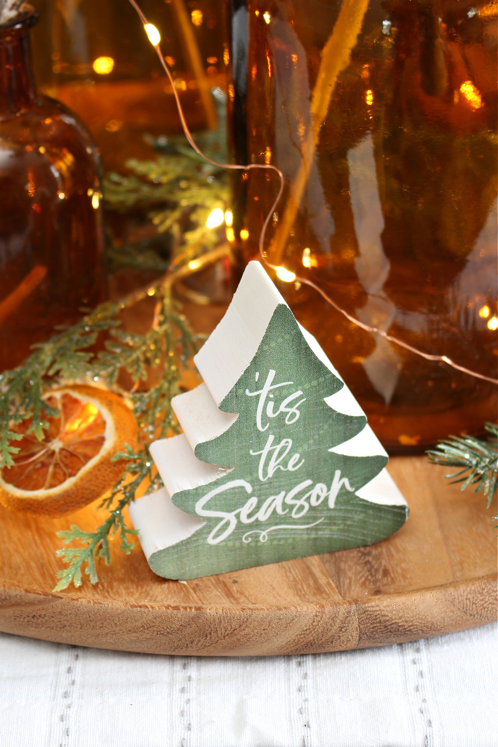 'Tis the Season wood tree on a Christmas centerpiece.