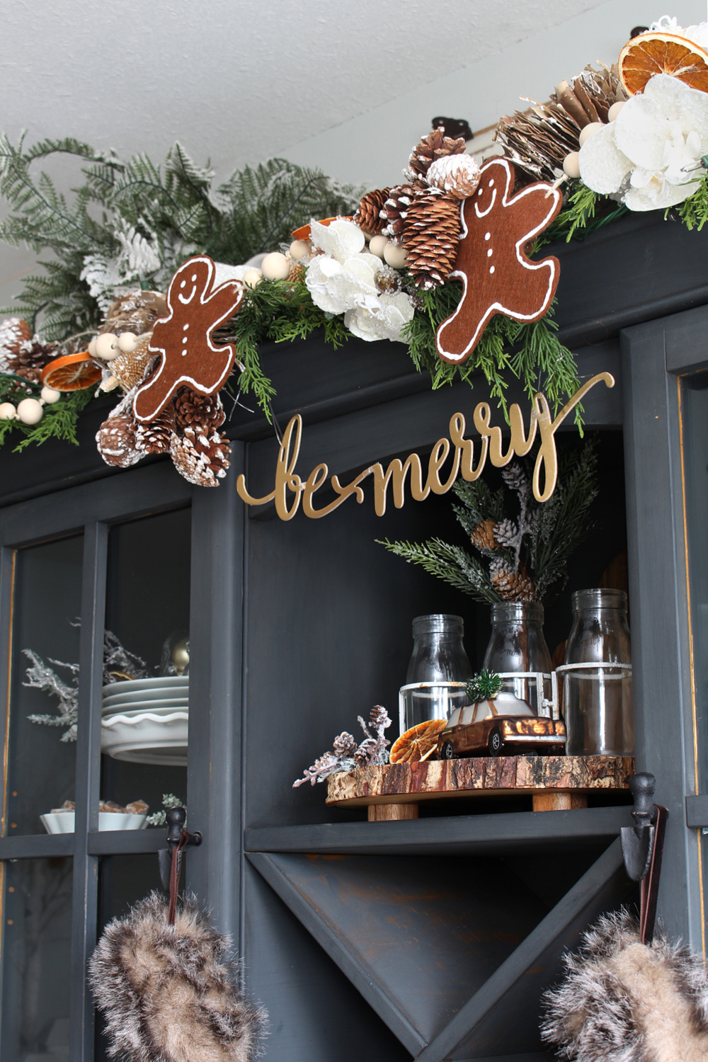 Black painted hutch decorated with a DIY felt gingerbread man bunting.