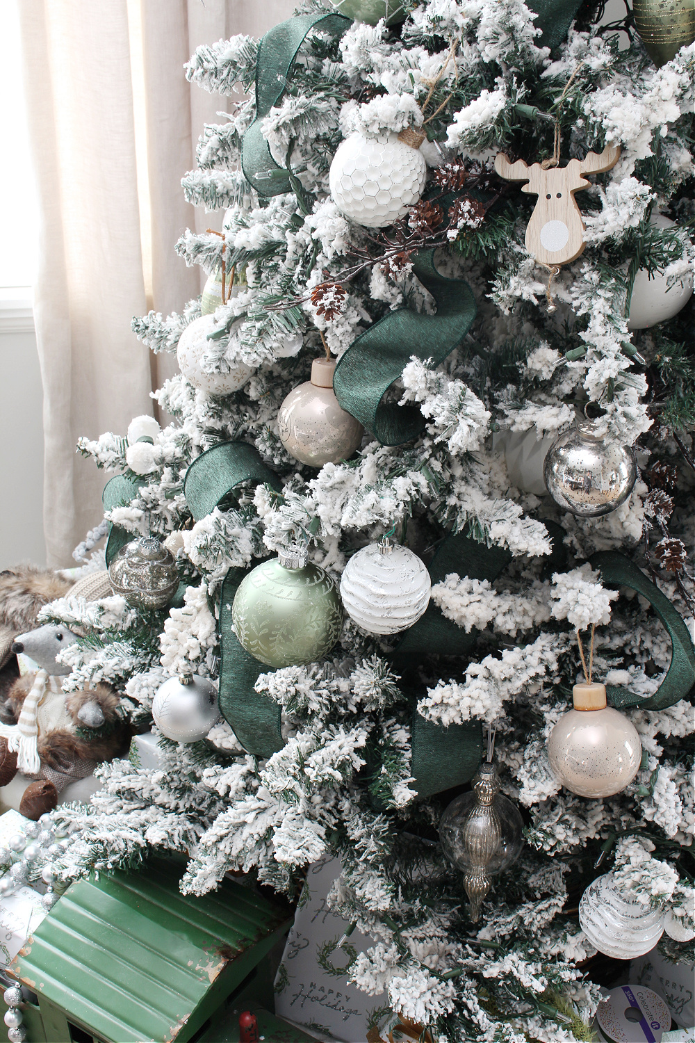 Flocked Christmas decorated with white, greens, and metallics.