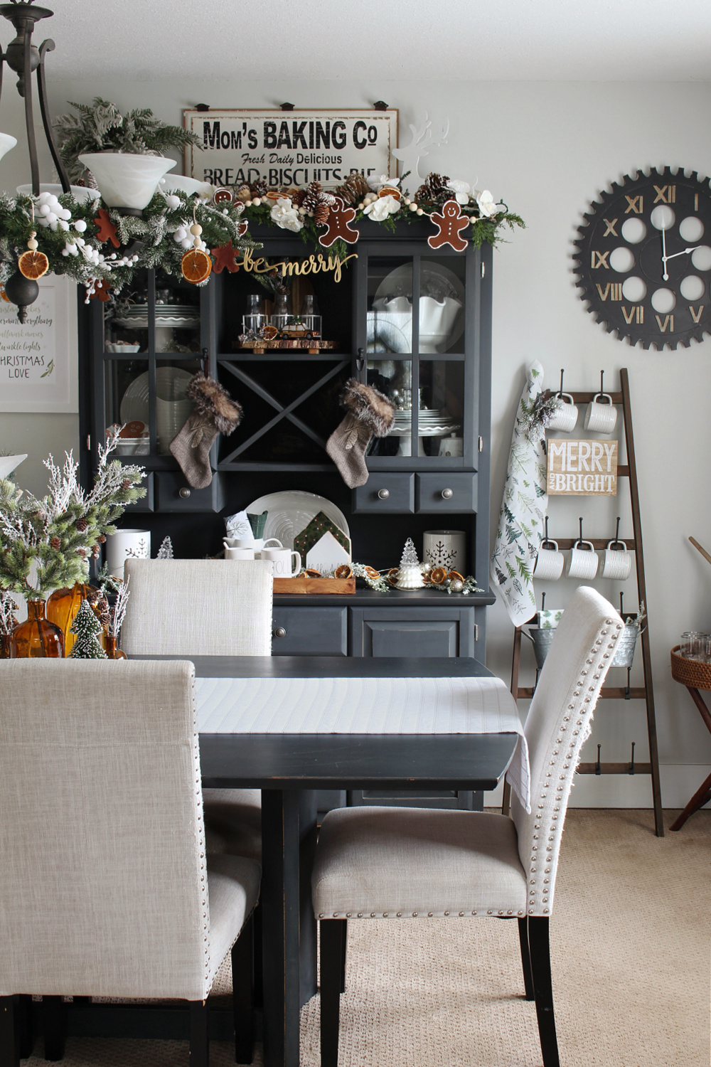Dining room with black painted table, buffet and hutch decorated for Christmas.