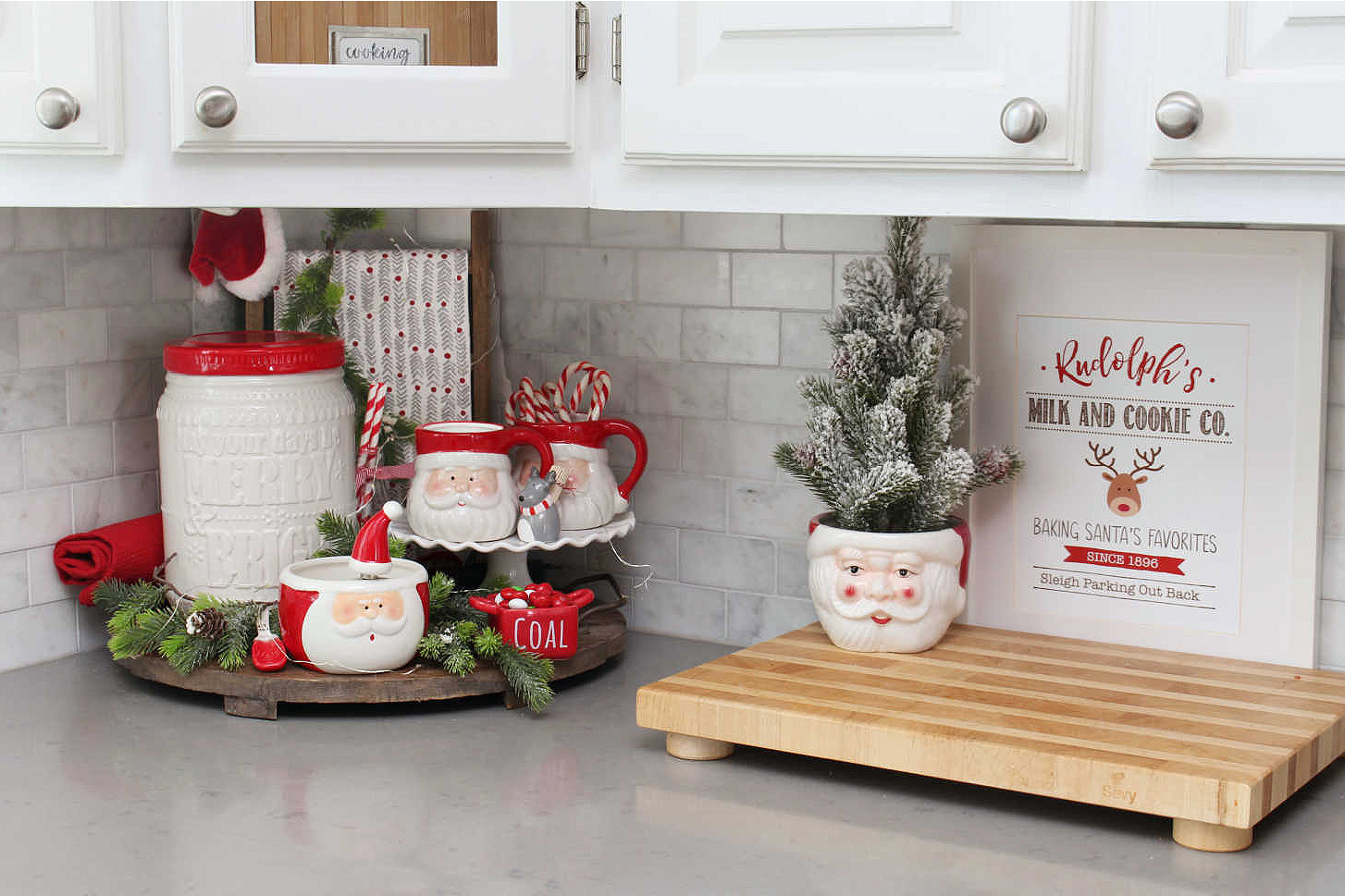 Red and white Christmas kitchen decor with Santa mugs.