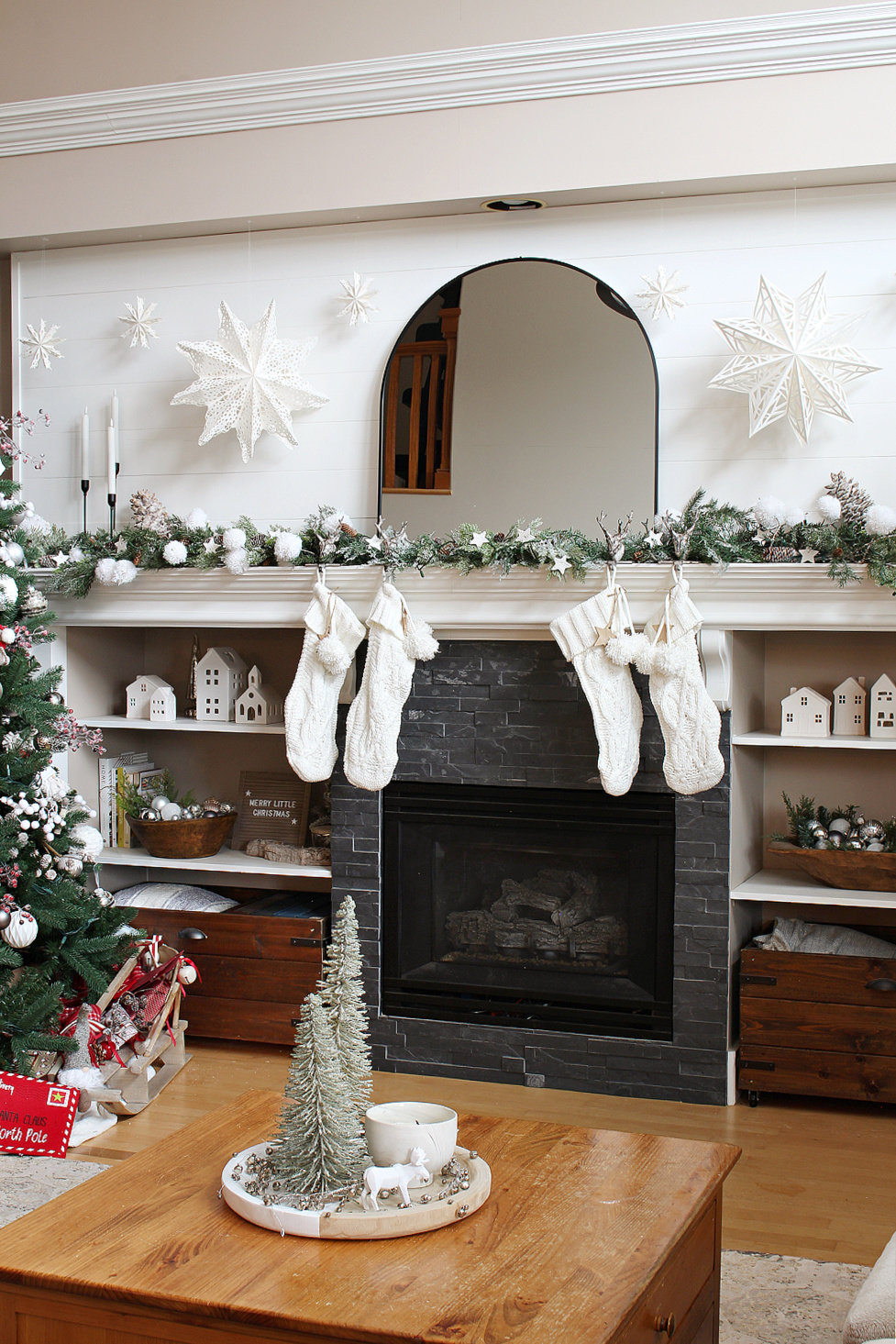 Winter wonderland Christmas mantel with black arched mirror.
