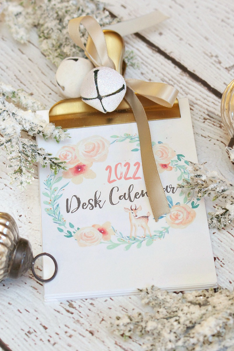 Free printable 2022 desk calendar clipped together with a gold clip.