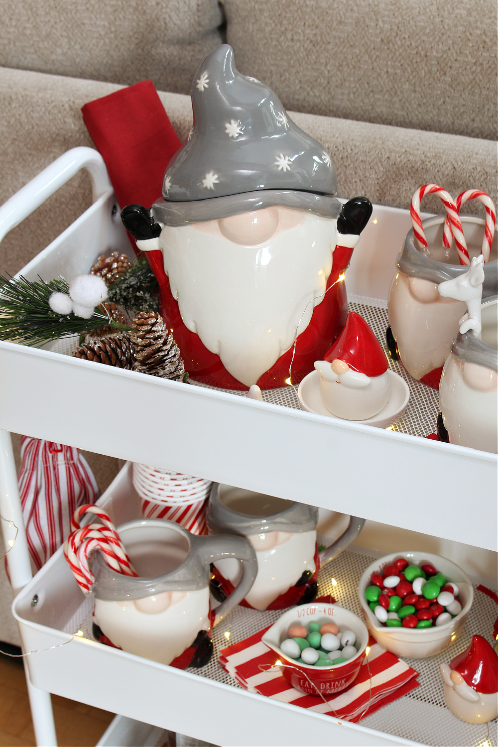 Cute Christmas hot chocolate bar cart with gnome cookie jar and mugs.