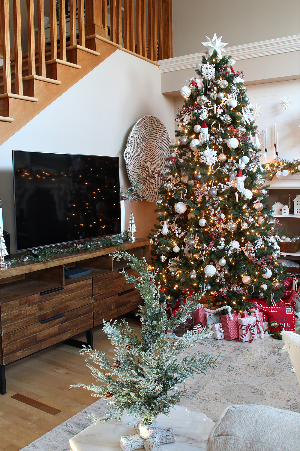Television stand and Christmas tree in a festive Christmas living room.