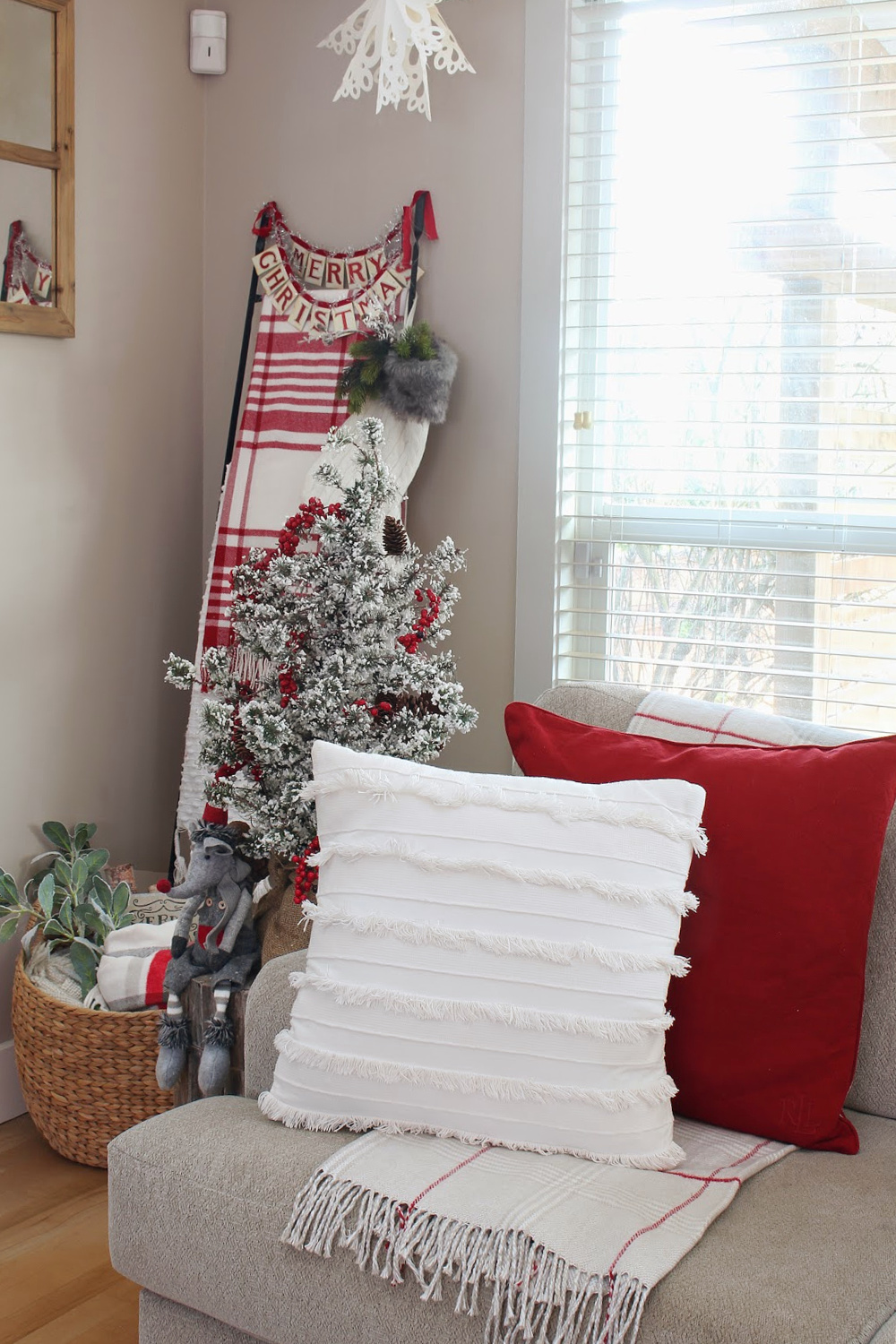 Festive living room with red and white pillows and throw blankets.