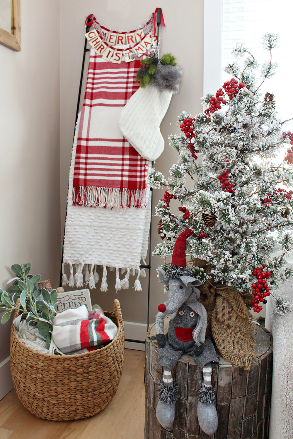 Blanket ladder and basket of blankets in a festive Christmas living room.