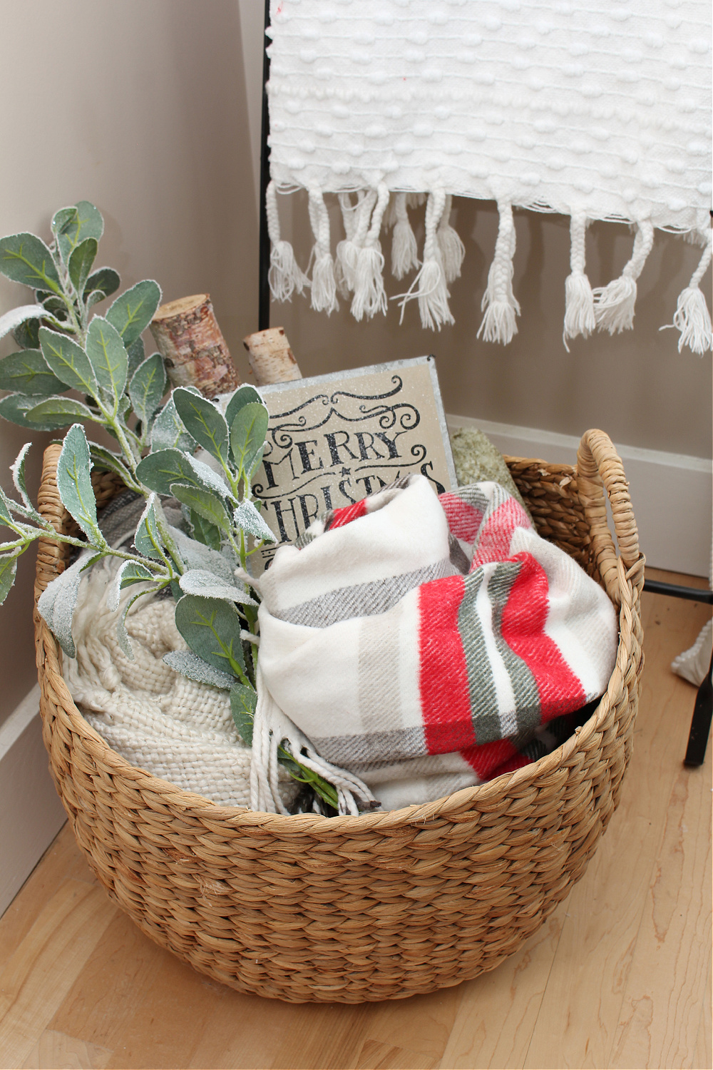 Basket filled with blankets in a festive Christmas living room.