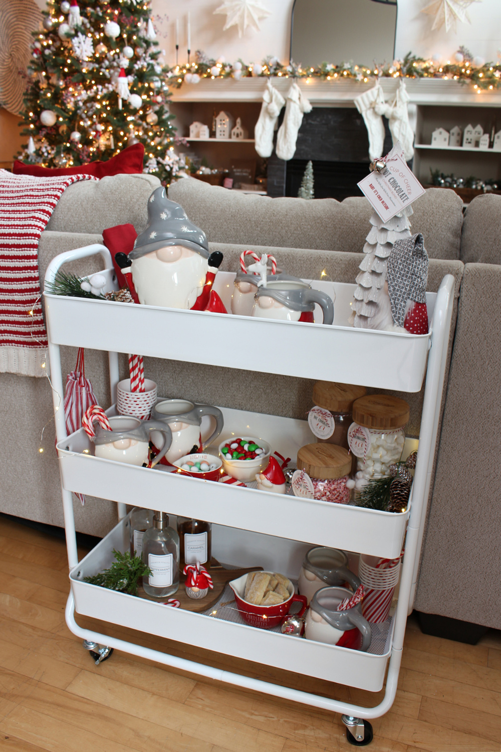 Cute hot chocolate bar cart with gnome mugs and cookie jar.