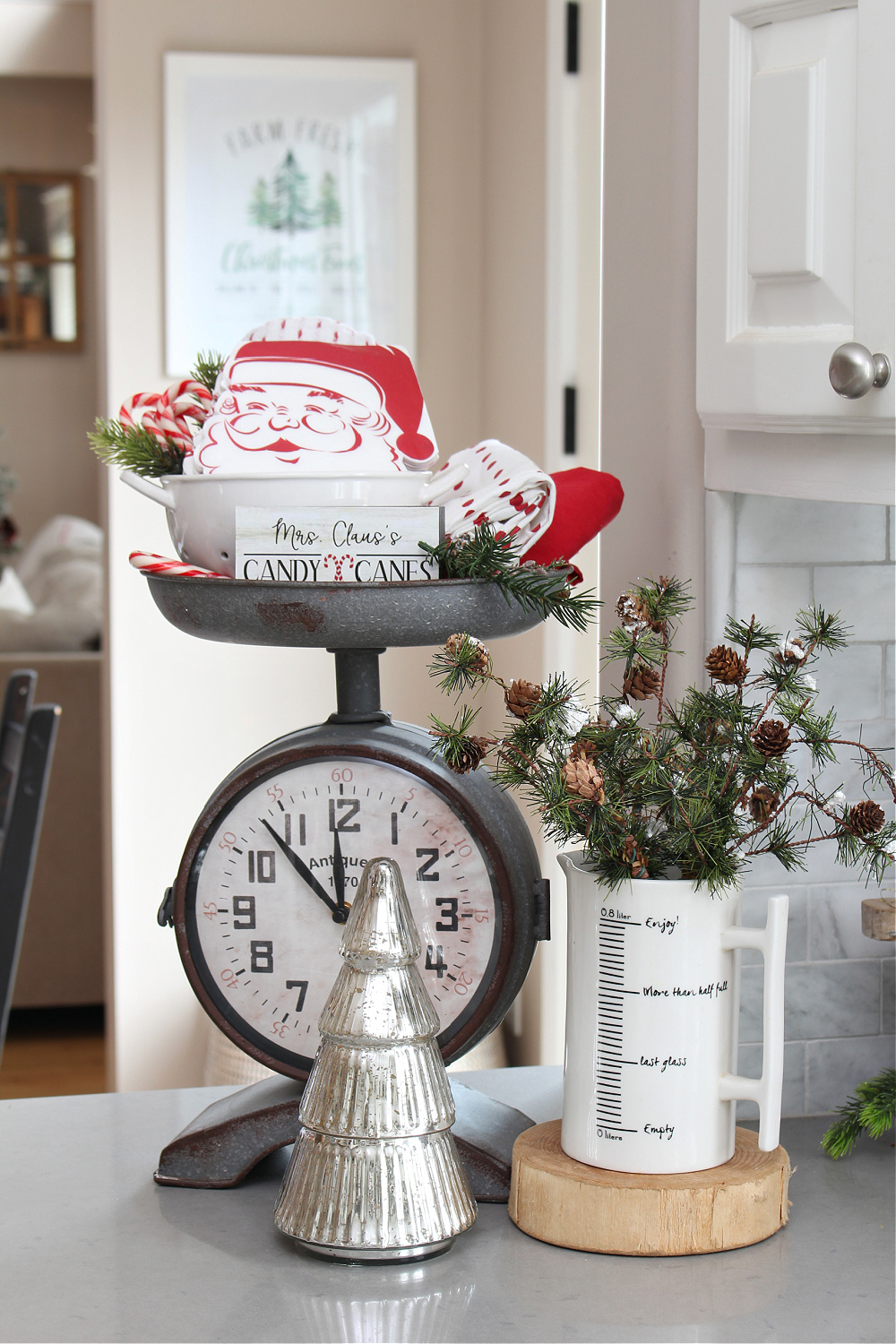 Christmas vignette with vintage inspired clock, red dish towels and Santa napkins.