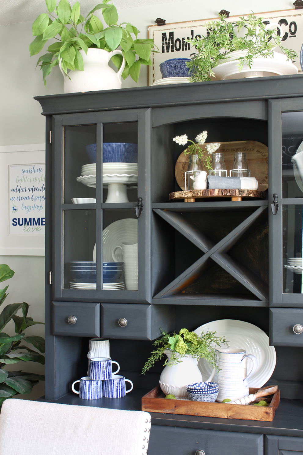 Black hutch decorated for summer with greens and blues.