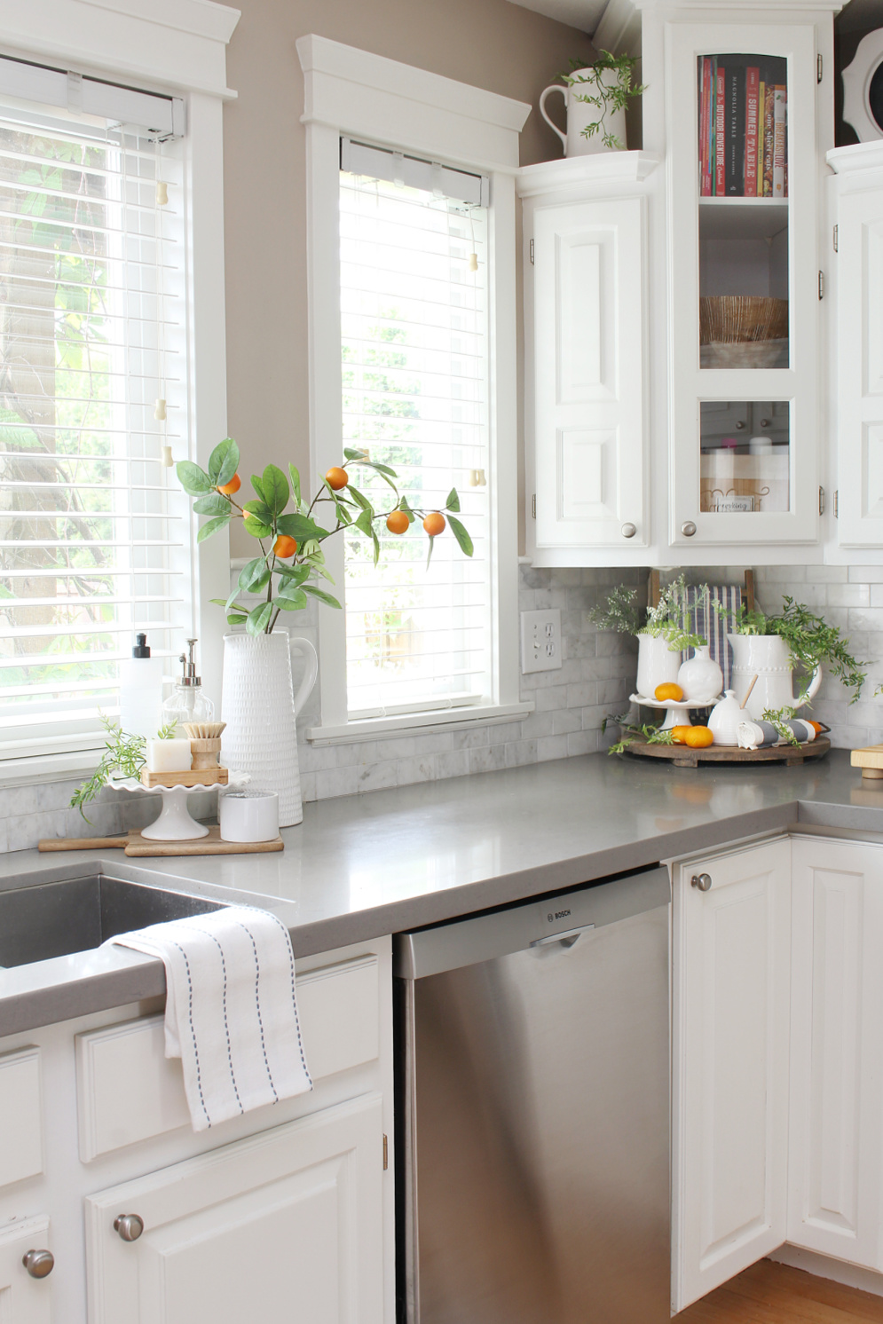 White kitchen decorated for summer with pops of orange.