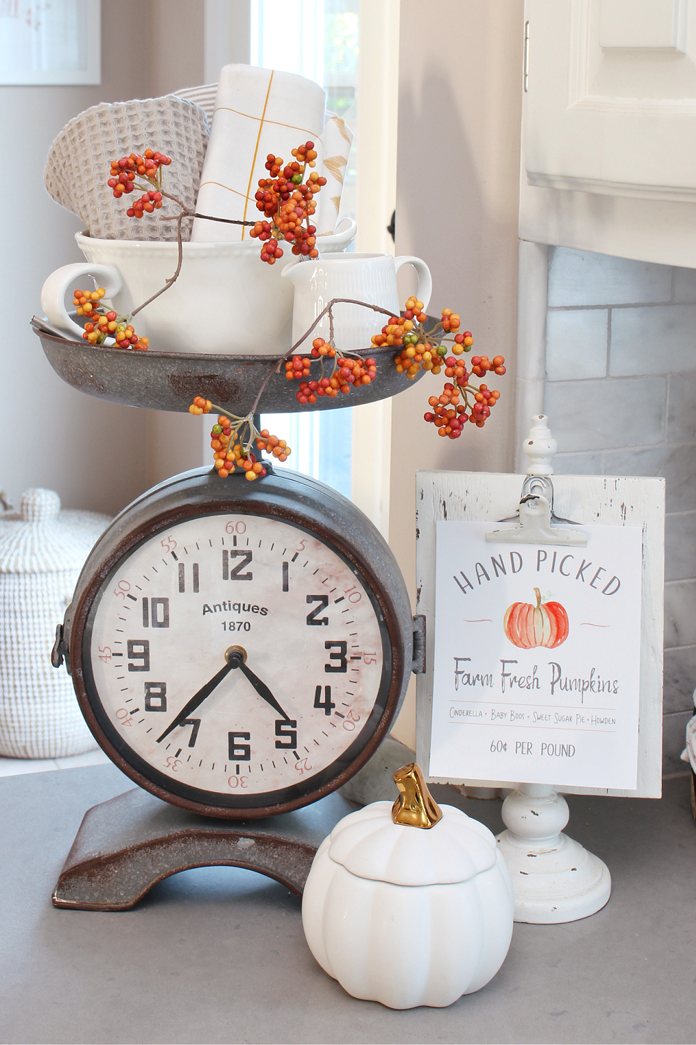 Faux scale clock decorated for fall.