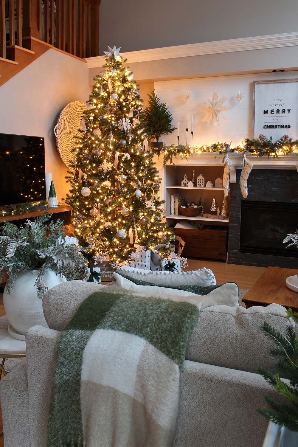Living room decorated for Christmas with green and white.