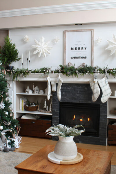 Living room decorated for Christmas with green and white.