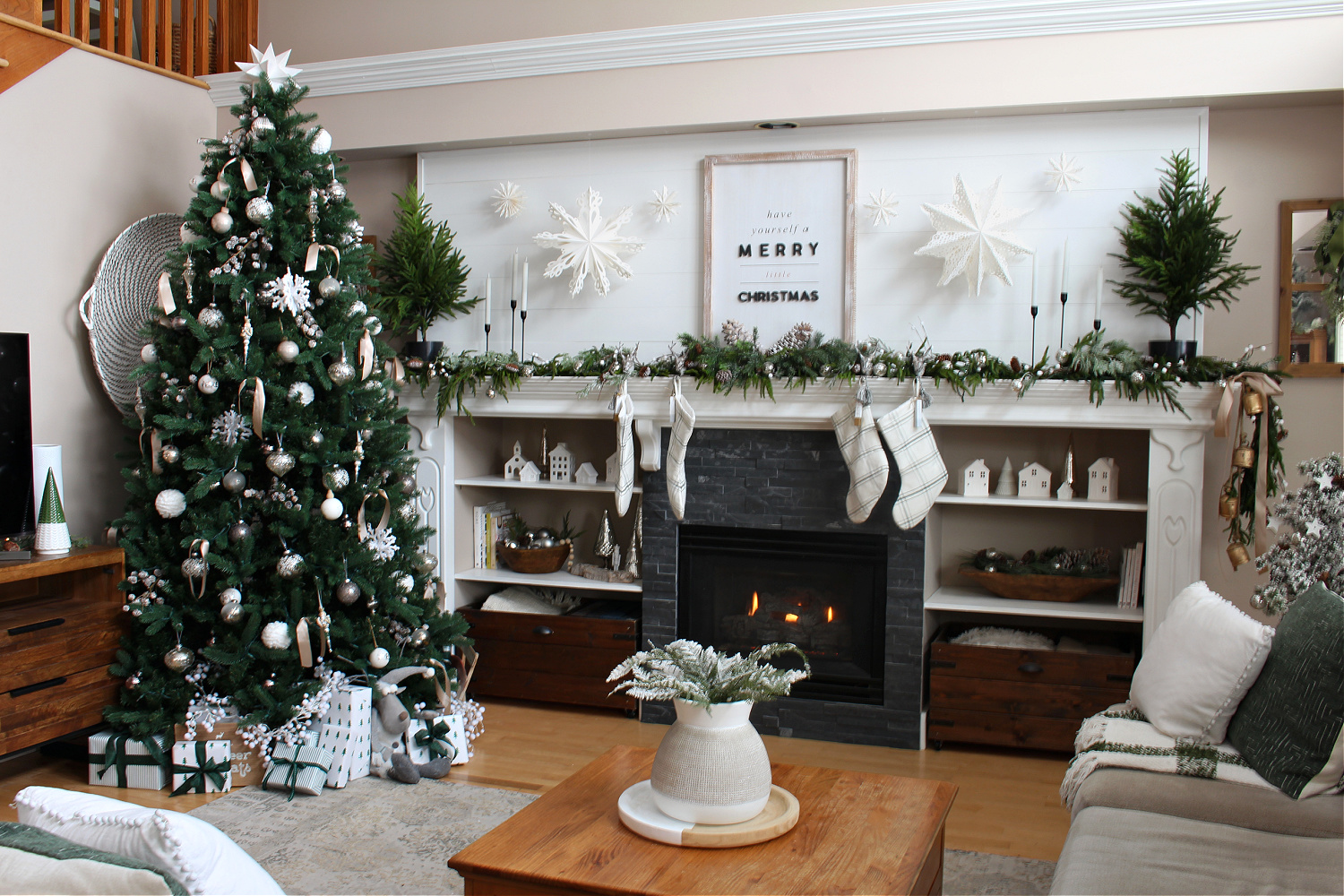 Living room decorated for Christmas in green and white.