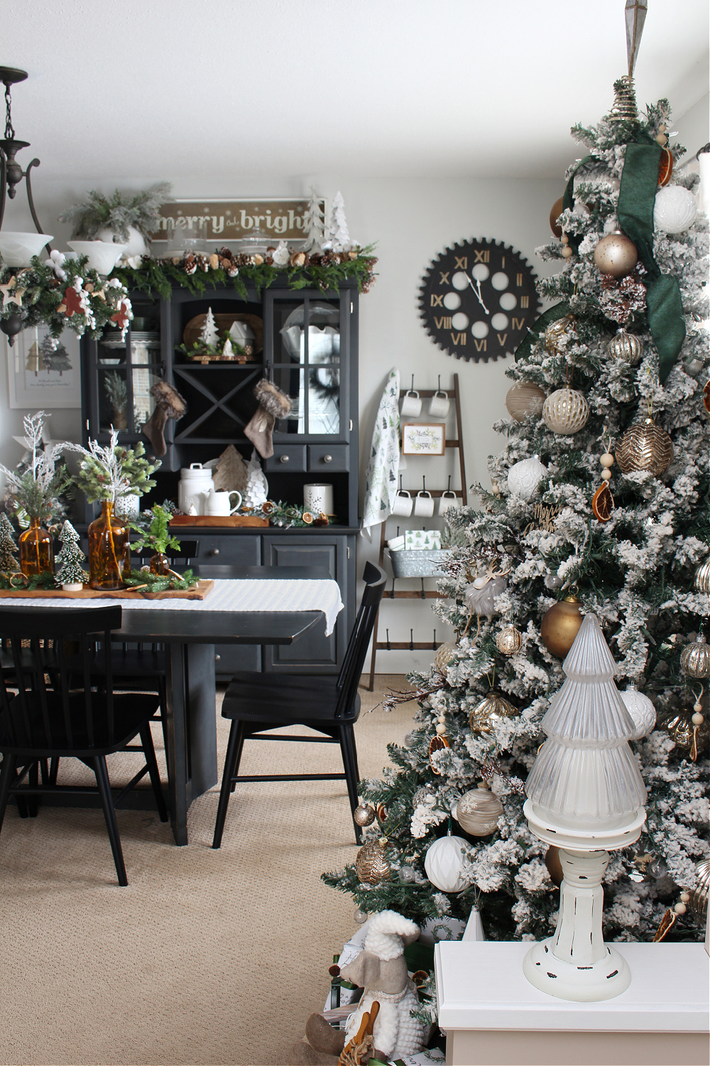 A Christmas dining room decorated in greens, amber, and metallics.