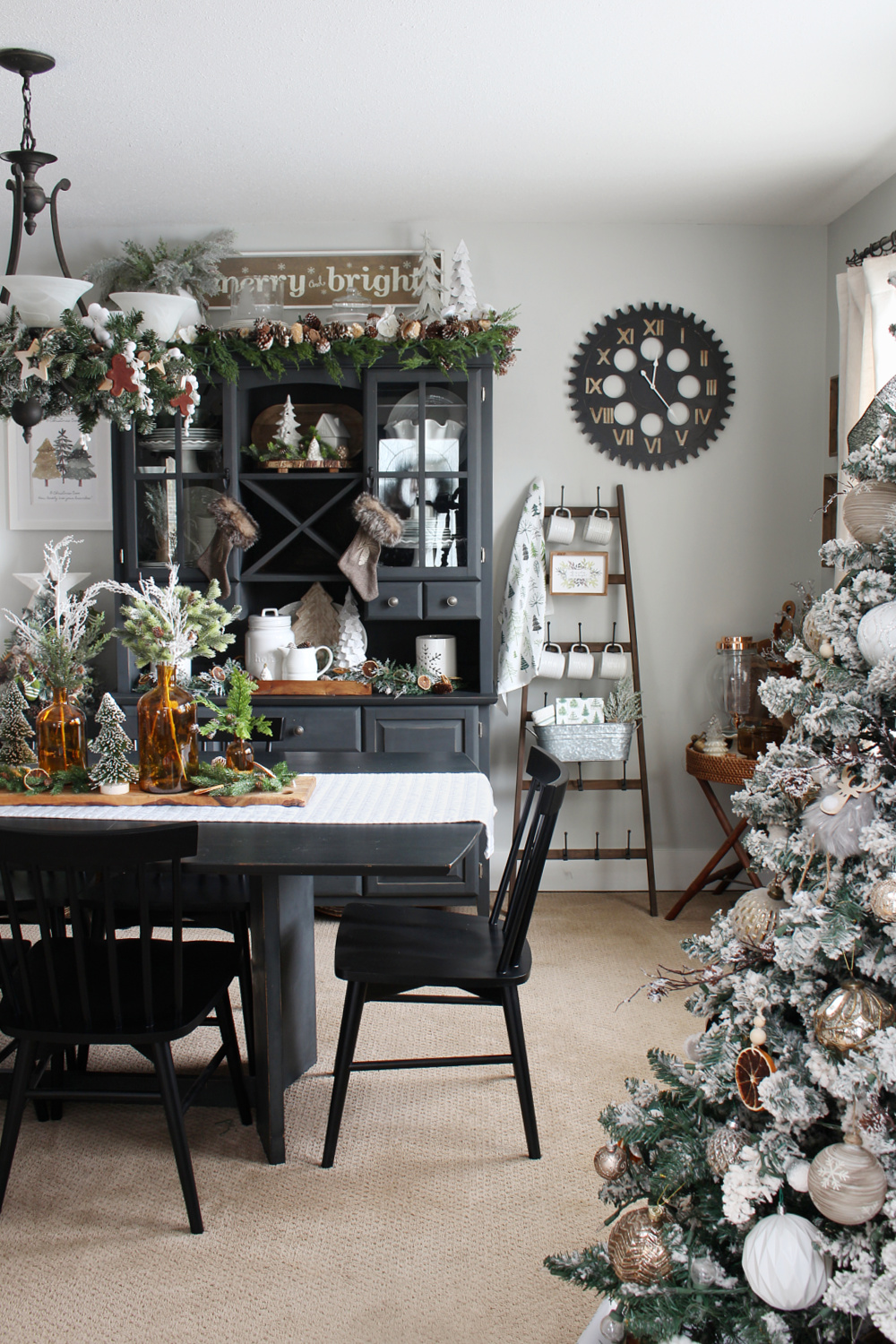 Christmas dining room decorated with greens, amber and metallics.