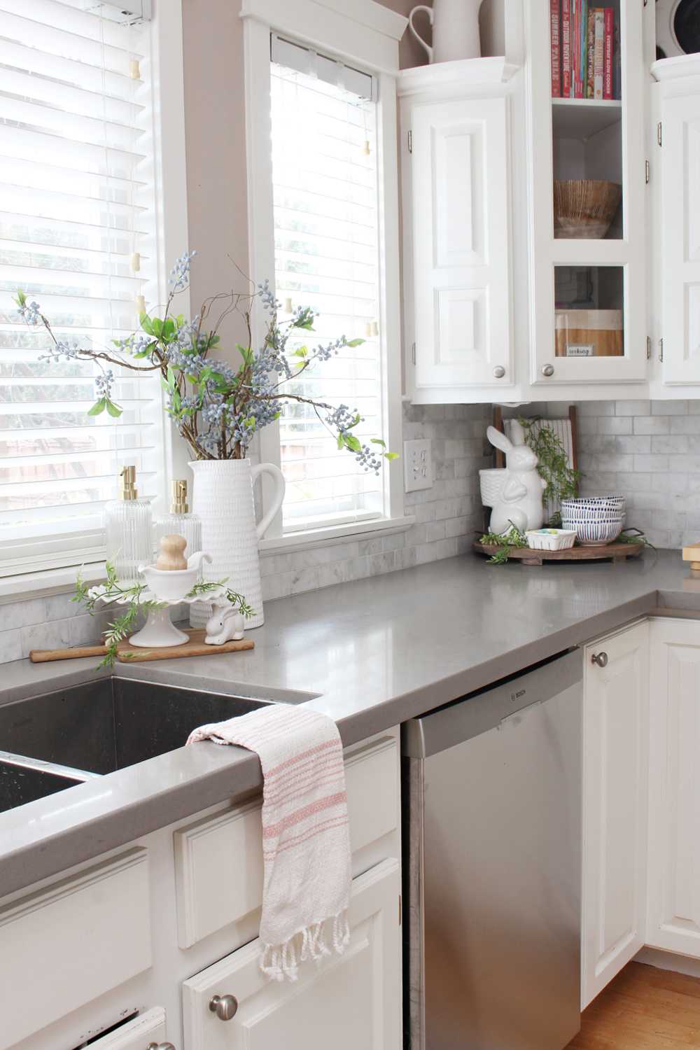 White kitchen decorated for spring with pops of blue and pink.