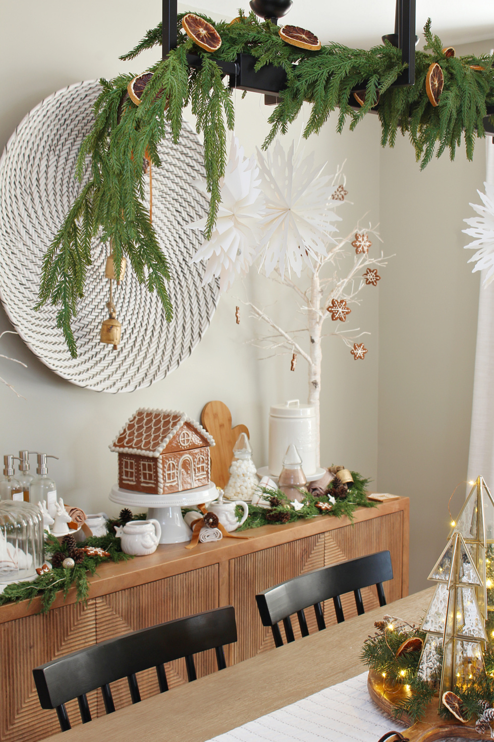 Modern dining room decorated for Christmas with a gingerbread house inspired theme.