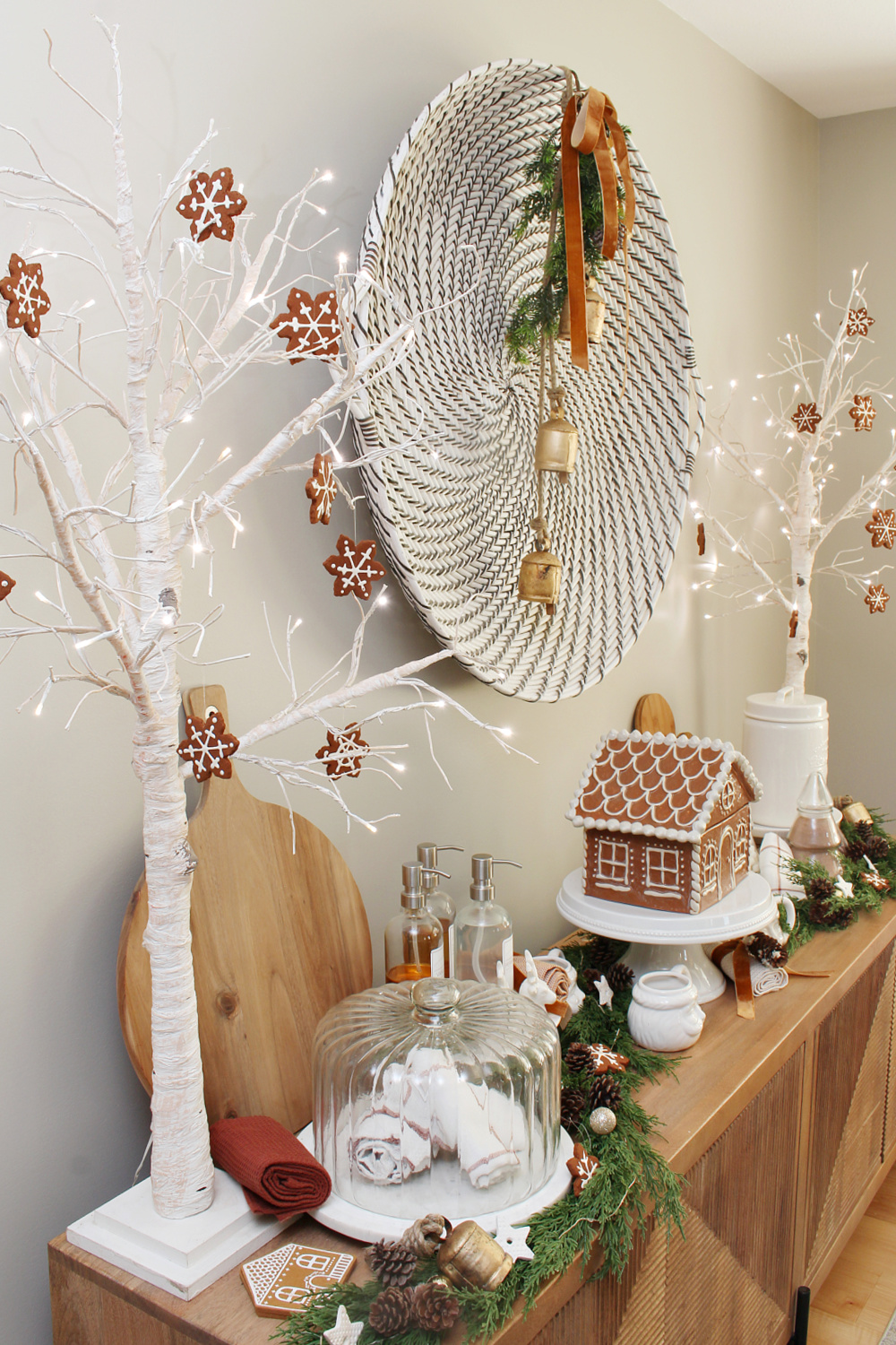 Faux gingerbread ornaments hung on a white birch lighted tree.