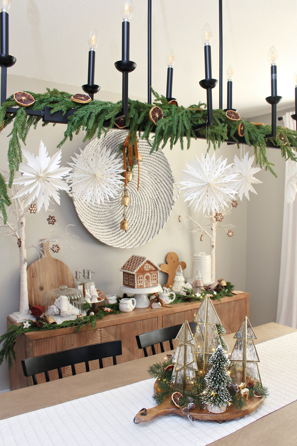 Modern dining room decorated for Christmas with a gingerbread house inspired theme.