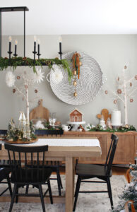 Modern dining room decorated for Christmas with a gingerbread house inspired theme.