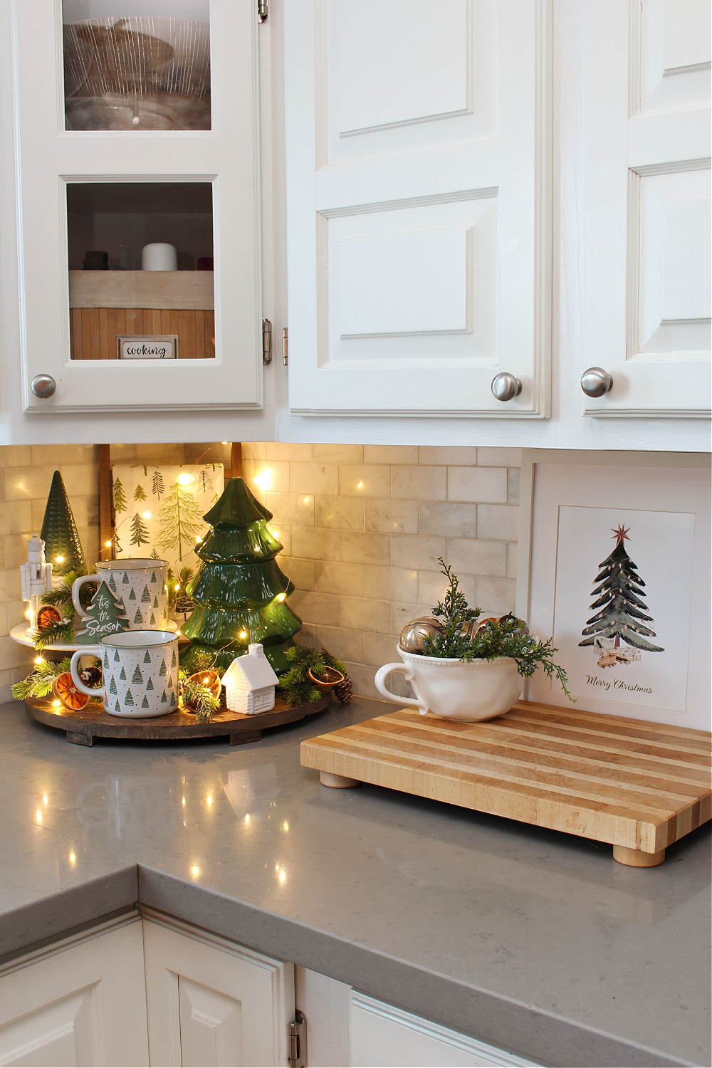 White Christmas kitchen with Christmas tree decor and Christmas tree art.