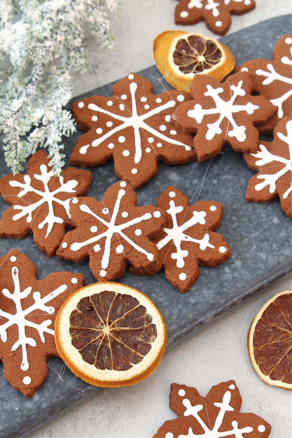 Faux gingerbread snowflake ornaments decorated with white puffy paint.